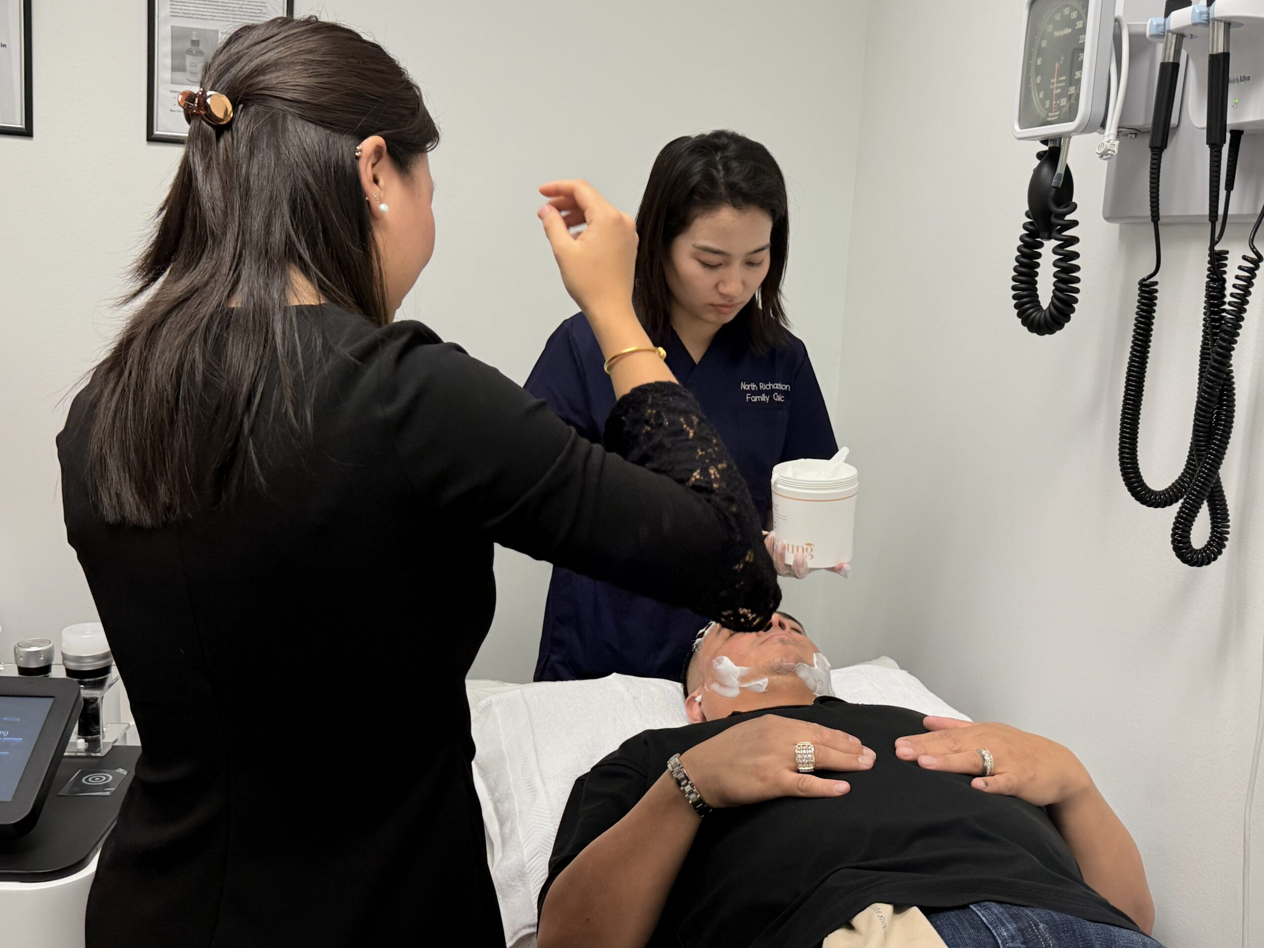 Matt receiving his first UltraSculpt facial treatment while a team member assists